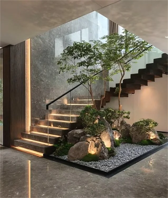 Staircase with a lit indoor garden feature set into the landing below